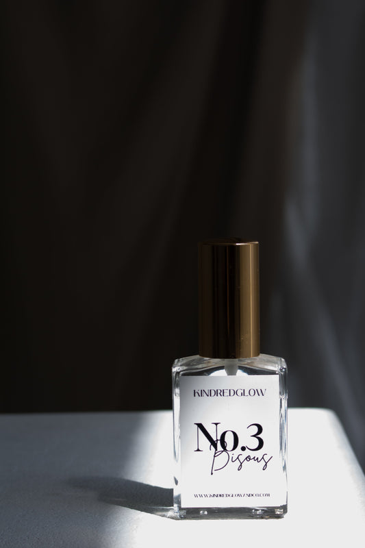 Perfume bottle labeled 'No.3' on a white surface with a dark background